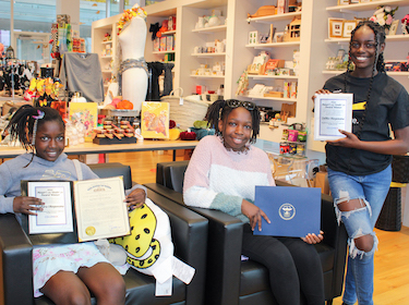 The Obayuwana sisters holding awards